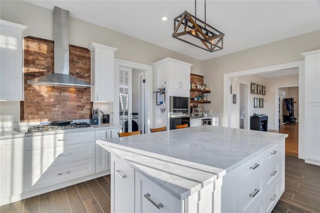 926 City Park Ave, New Orleans, LA 70119 - kitchen featuring a center island, stainless steel appliances, wall chimney range hood, and wood tiled floor