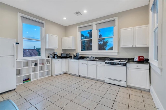 926 City Park Ave, New Orleans, LA 70119 - kitchen with visible vents, a sink, dark countertops, white appliances, and white cabinets