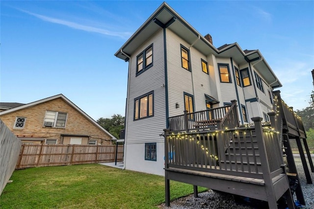 926 City Park Ave, New Orleans, LA 70119 - rear view of property featuring a yard, a fenced backyard, a chimney, and a wooden deck