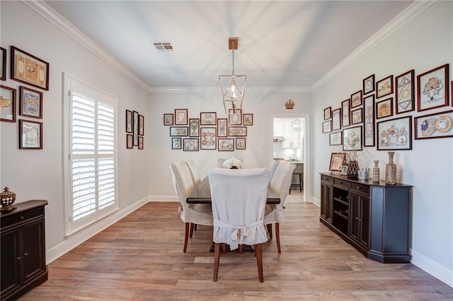 dining space featuring visible vents, ornamental molding, and light wood finished floors