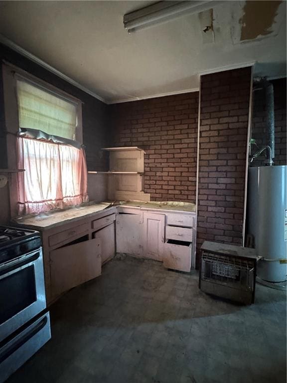 kitchen with brick wall, light countertops, ornamental molding, water heater, and electric stove