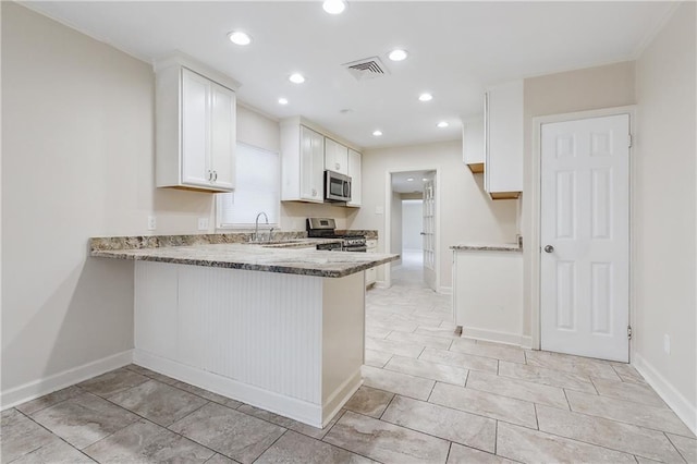 kitchen featuring visible vents, light stone counters, appliances with stainless steel finishes, a peninsula, and white cabinets