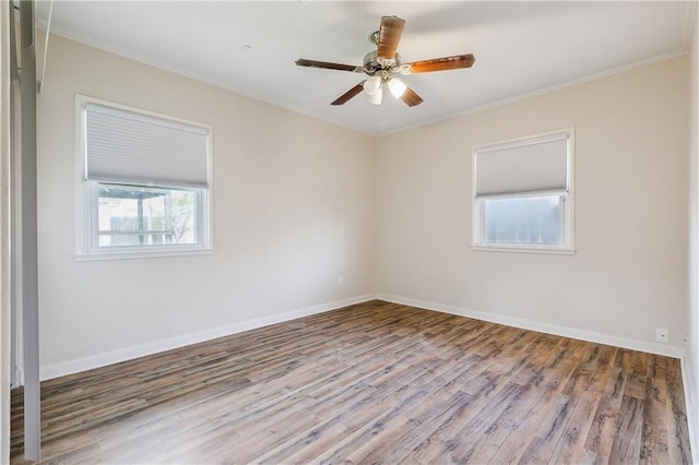 unfurnished room featuring baseboards and wood finished floors