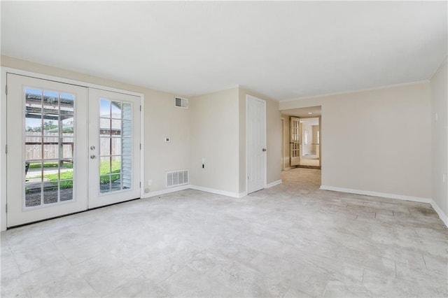 spare room featuring french doors, visible vents, and baseboards