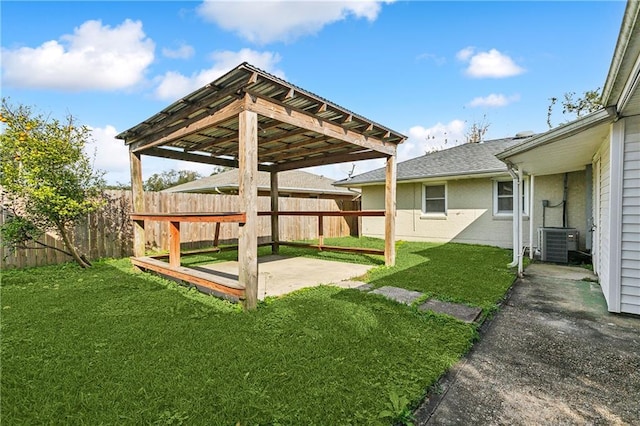 view of yard featuring central AC unit, a patio, and fence