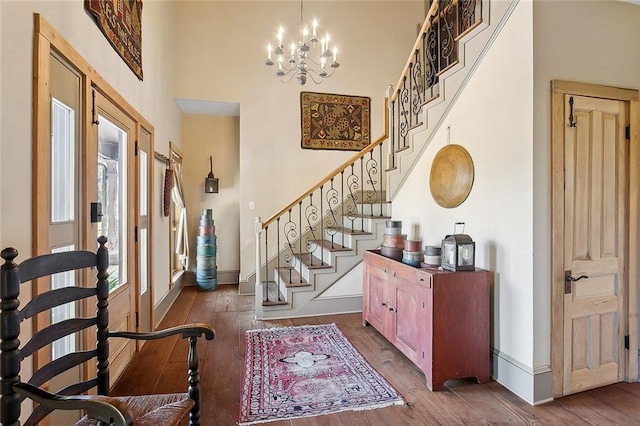 entryway with hardwood / wood-style flooring, a high ceiling, and a wealth of natural light