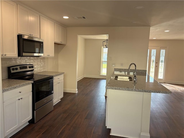 kitchen featuring a sink, white cabinets, visible vents, and stainless steel appliances