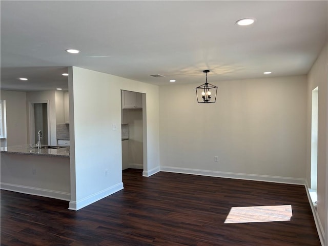 interior space with visible vents, a sink, baseboards, recessed lighting, and dark wood-style flooring