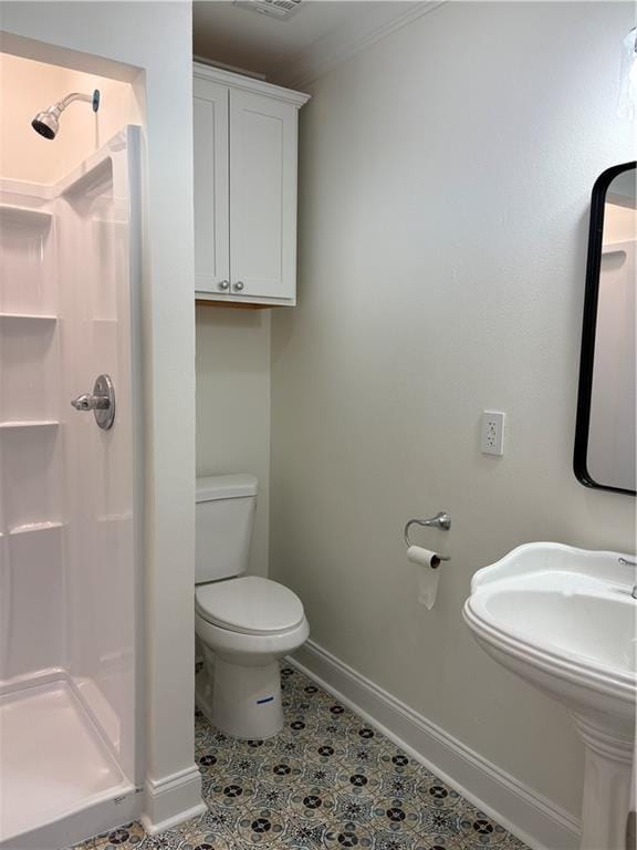 full bathroom featuring tile patterned flooring, toilet, baseboards, and a stall shower