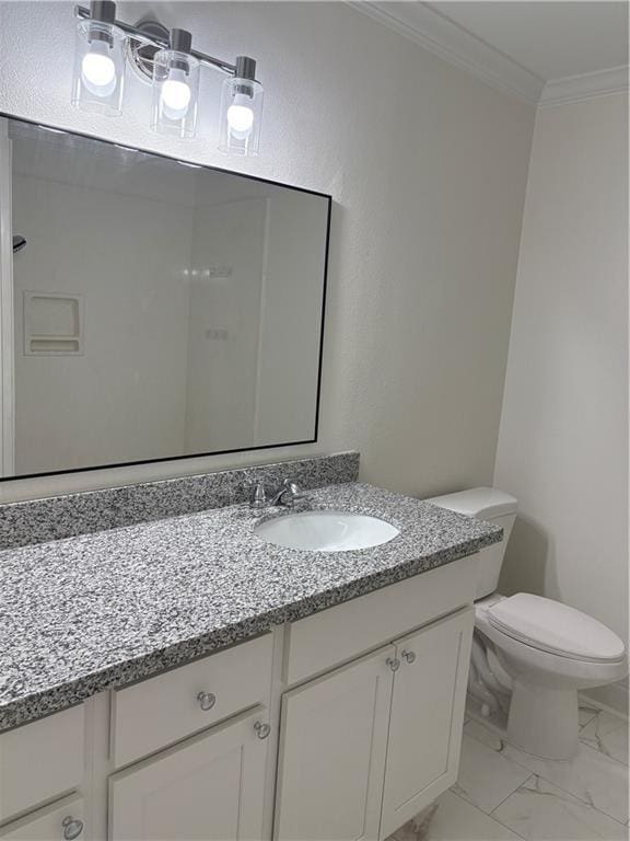 bathroom featuring marble finish floor, vanity, crown molding, and toilet