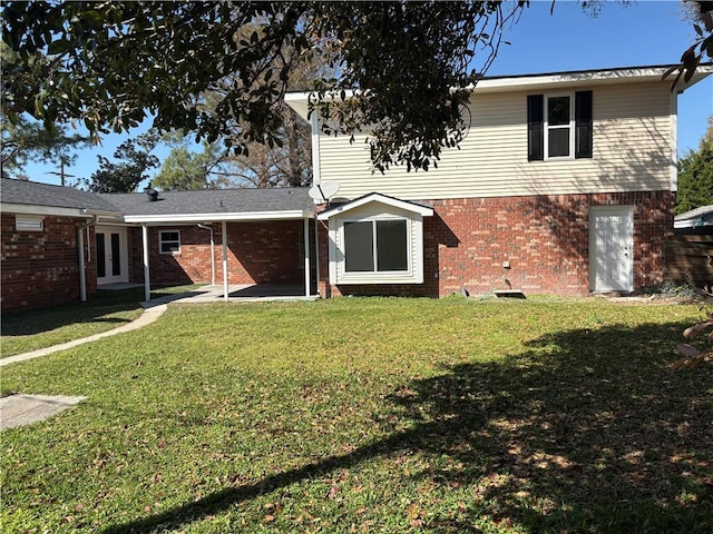 rear view of property featuring a patio, french doors, brick siding, and a lawn