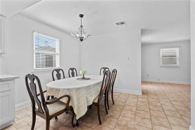 dining area with a notable chandelier, baseboards, visible vents, and light tile patterned floors