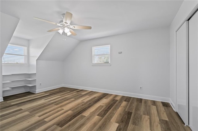 bonus room with lofted ceiling, wood finished floors, baseboards, and ceiling fan