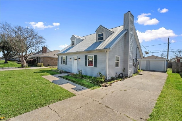 cape cod home featuring an outbuilding, a front lawn, a detached garage, concrete driveway, and metal roof