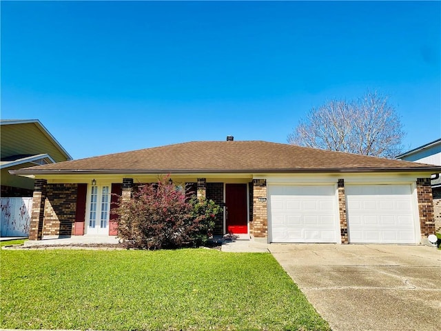 ranch-style house featuring brick siding, a shingled roof, concrete driveway, a front yard, and an attached garage