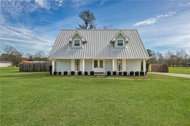 cape cod-style house featuring a front lawn, fence, covered porch, and metal roof