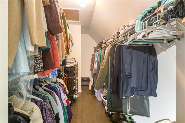 spacious closet featuring lofted ceiling and wood finished floors