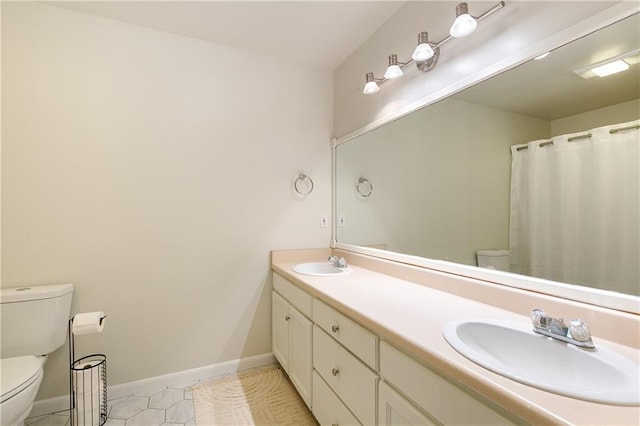 full bath featuring tile patterned flooring, toilet, baseboards, and a sink