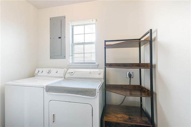 washroom with electric panel, laundry area, and separate washer and dryer