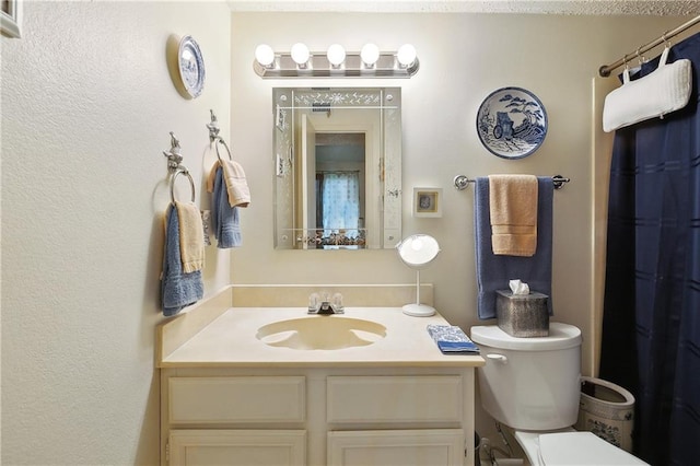 bathroom with toilet and vanity