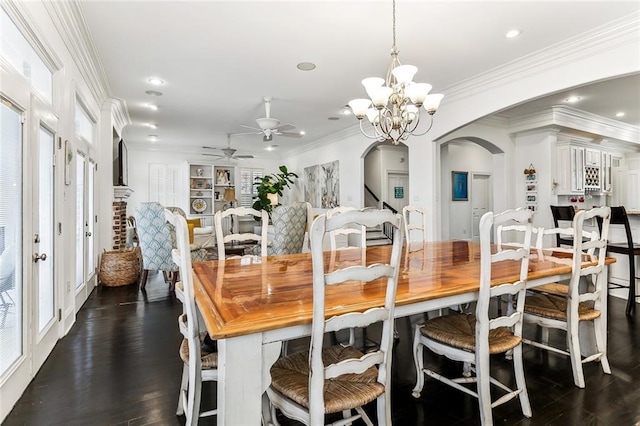 dining area with ornamental molding, ceiling fan with notable chandelier, dark wood finished floors, recessed lighting, and arched walkways