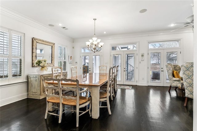 dining space with visible vents, baseboards, dark wood-type flooring, french doors, and crown molding