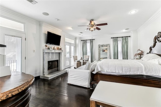 bedroom featuring a ceiling fan, wood finished floors, visible vents, a high end fireplace, and crown molding