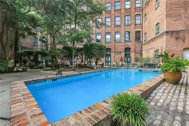 view of swimming pool featuring a pool with connected hot tub