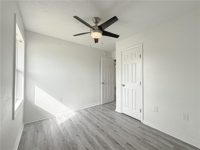 1117 Mercury Ave, Metairie, LA 70003 - spare room featuring baseboards, a textured ceiling, and wood finished floors