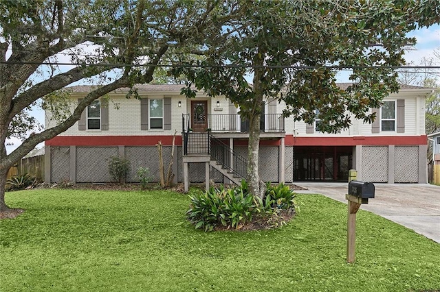 beach home featuring stairs, a carport, concrete driveway, and a front lawn