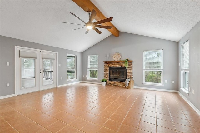 unfurnished living room with light tile patterned floors, a fireplace, vaulted ceiling with beams, and ceiling fan