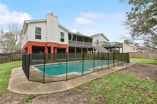 view of swimming pool featuring a fenced in pool, stairway, a yard, a fenced backyard, and a deck