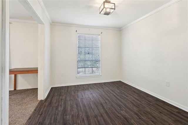 spare room featuring dark wood-style floors, baseboards, and ornamental molding