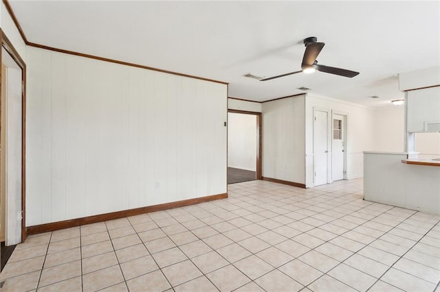 spare room with ceiling fan, visible vents, and ornamental molding