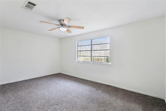 spare room with visible vents, carpet flooring, baseboards, and a ceiling fan