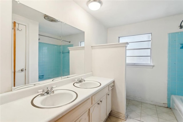 bathroom with a sink, bathing tub / shower combination, and double vanity