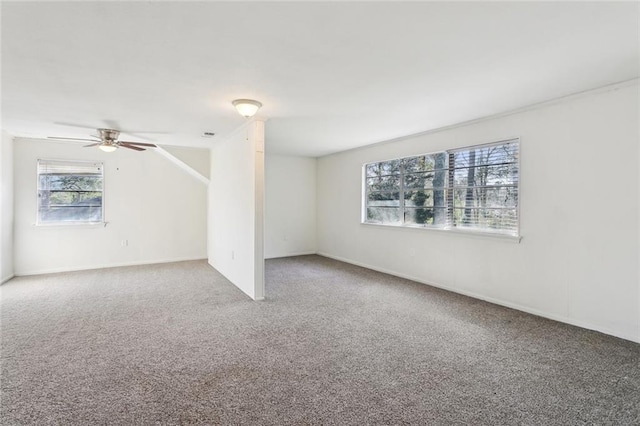 carpeted spare room with a ceiling fan