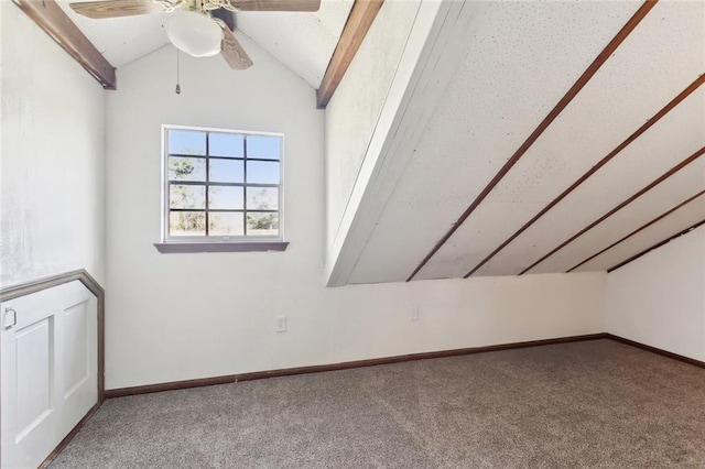 interior space featuring ceiling fan, baseboards, lofted ceiling, and carpet floors