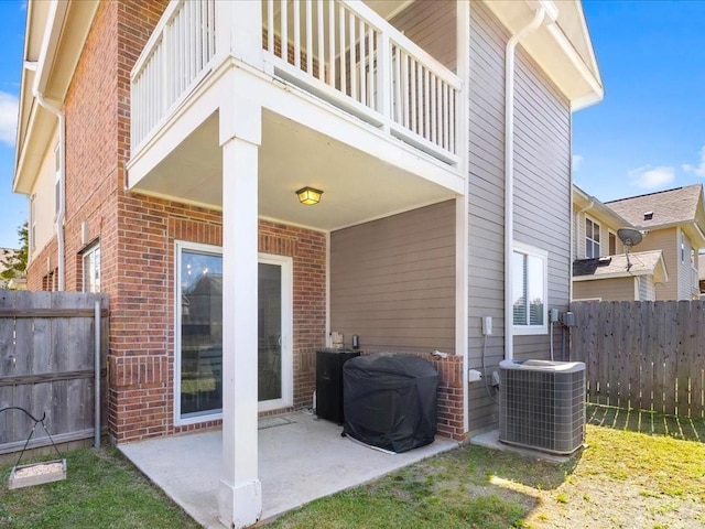 exterior space featuring a balcony, central air condition unit, and fence