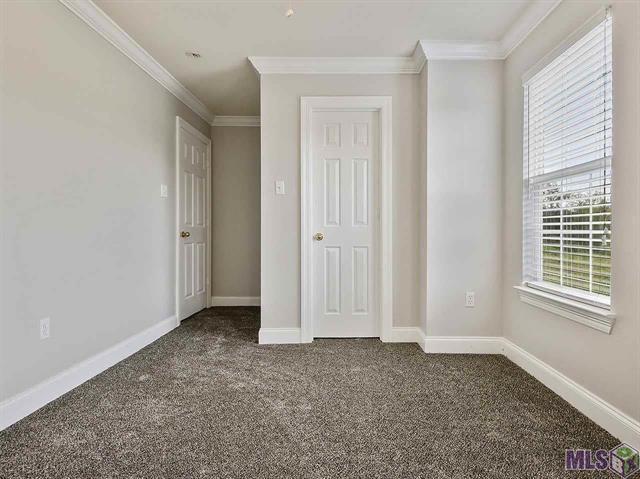 1500 Brightside Dr Unit D6, Baton Rouge, LA 70820 - unfurnished bedroom featuring dark colored carpet, baseboards, and ornamental molding
