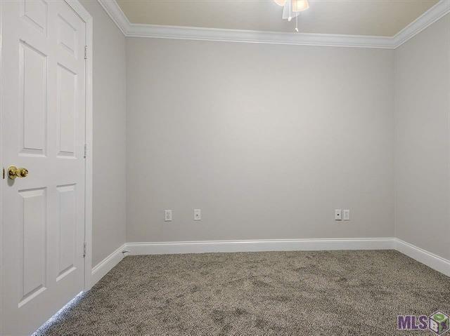 1500 Brightside Dr Unit D6, Baton Rouge, LA 70820 - empty room featuring crown molding, carpet flooring, and baseboards