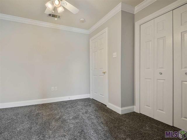 1500 Brightside Dr Unit D6, Baton Rouge, LA 70820 - unfurnished bedroom with visible vents, ornamental molding, a closet, carpet floors, and baseboards