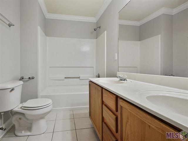 1500 Brightside Dr Unit D6, Baton Rouge, LA 70820 - bathroom featuring a sink, toilet, tile patterned floors, and crown molding