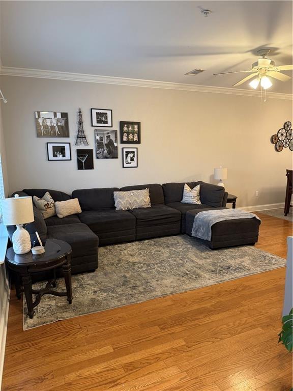 1500 Brightside Dr Unit D6, Baton Rouge, LA 70820 - living area featuring a ceiling fan, wood finished floors, baseboards, and ornamental molding