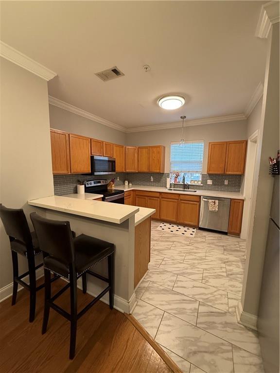 1500 Brightside Dr Unit D6, Baton Rouge, LA 70820 - kitchen featuring visible vents, a sink, light countertops, appliances with stainless steel finishes, and marble finish floor