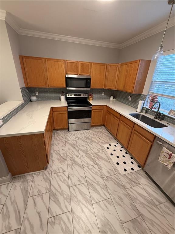 1500 Brightside Dr Unit D6, Baton Rouge, LA 70820 - kitchen featuring light countertops, brown cabinets, marble finish floor, stainless steel appliances, and a sink