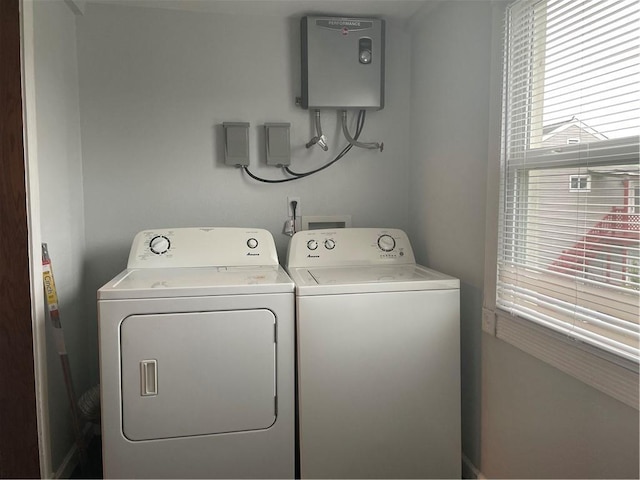 clothes washing area with laundry area, independent washer and dryer, and water heater