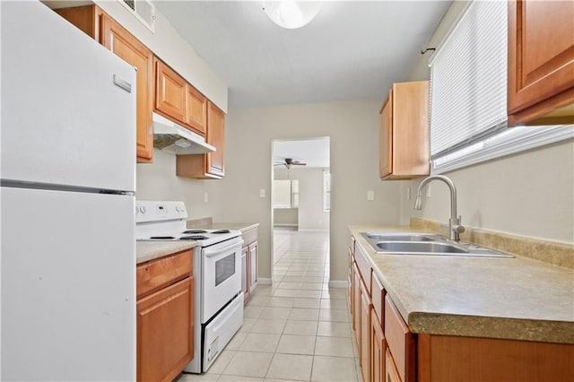 kitchen with white appliances, light tile patterned flooring, ceiling fan, a sink, and under cabinet range hood