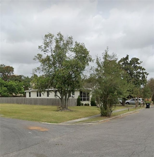 view of front facade with a front yard and fence