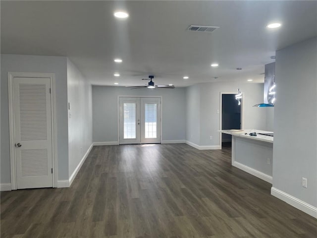 unfurnished room featuring dark wood-type flooring, french doors, visible vents, and baseboards